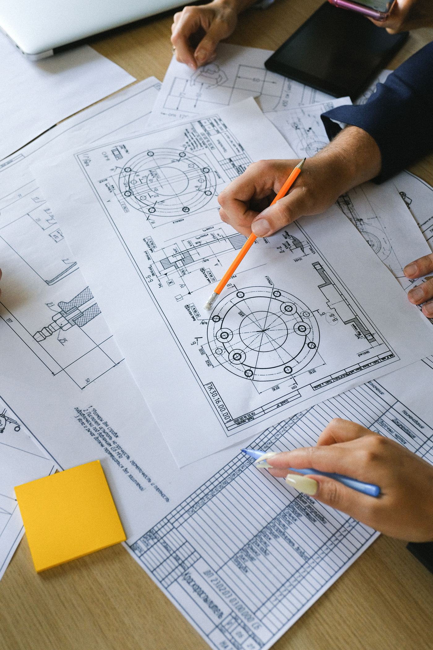Building layout drawings being reviewed
