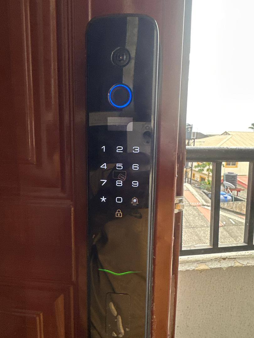 Fingerprint and keypad smart door lock installed on wooden door